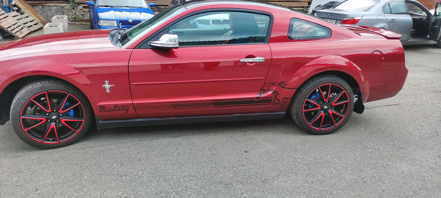 Druhý bok Mustangu s černou grafikou při spodní hraně