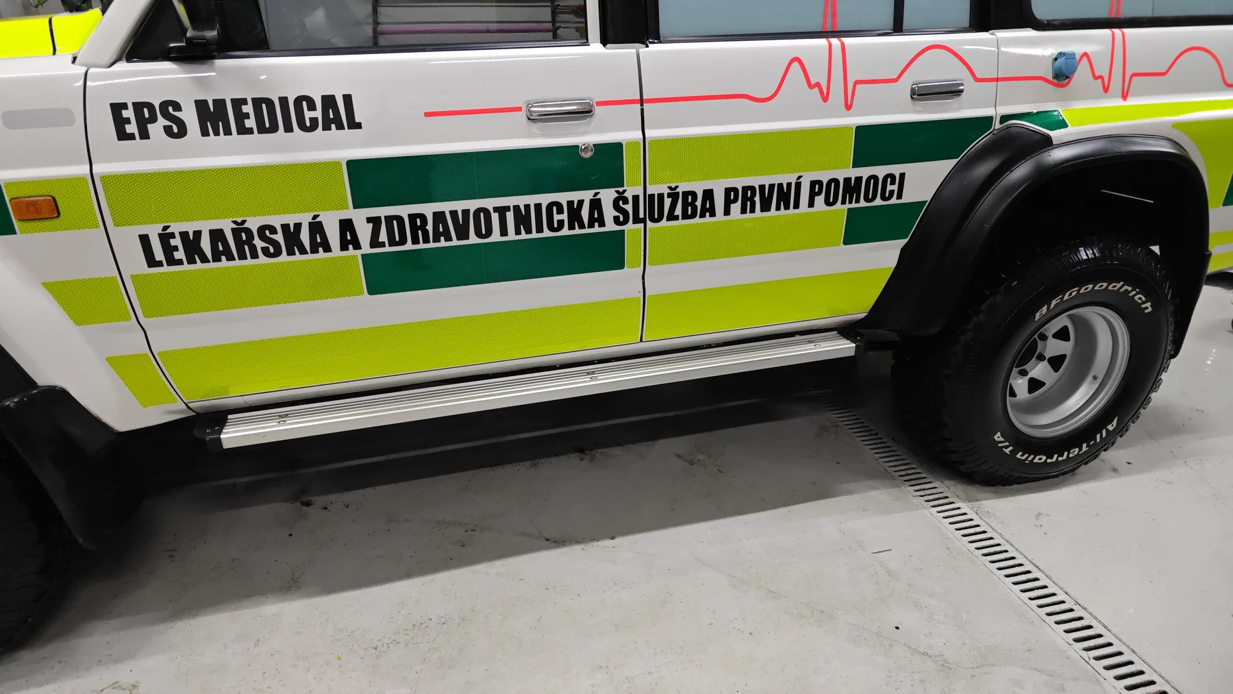 Detail bočního polepu Nissanu Patrol s nápisy EPS Medical a červenou křivkou